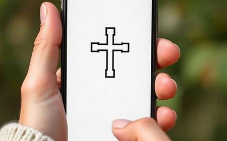 Handy mit Kreuz auf dem Display